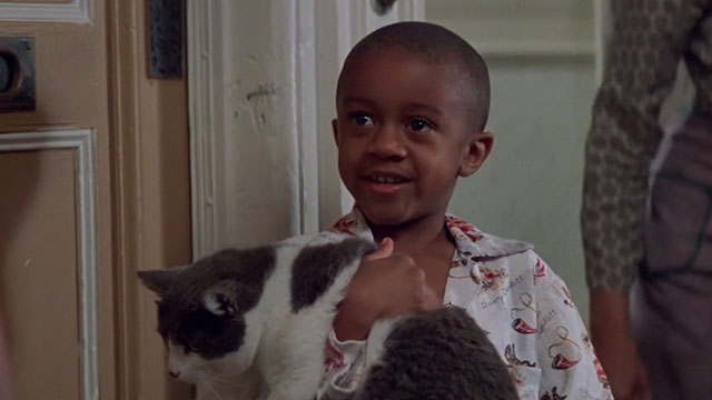 Heart and Souls - Billy Javar David Levingston holding gray and white cat