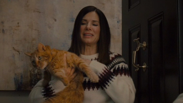 The Heat - Ashburn Sandra Bullock awkardly holding orange tabby cat Pumpkin