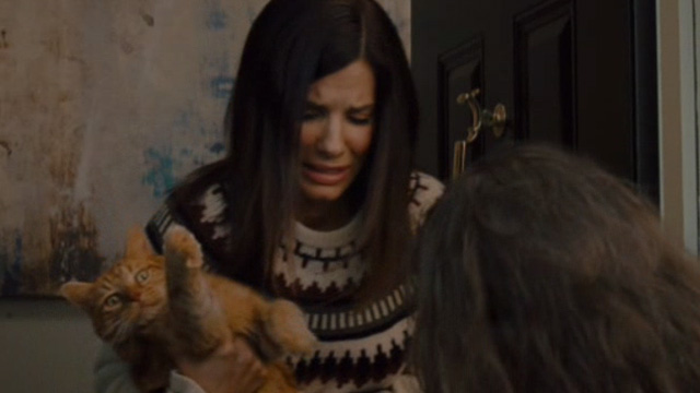 The Heat - Ashburn Sandra Bullock awkardly holding orange tabby cat Pumpkin