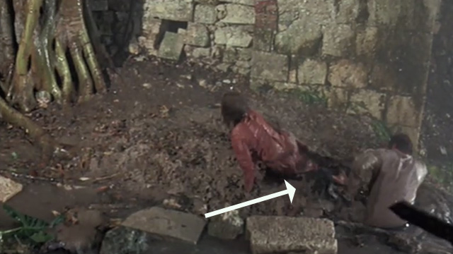 A High Wind in Jamaica - Tabby cat on muddy ground between Emily and her father