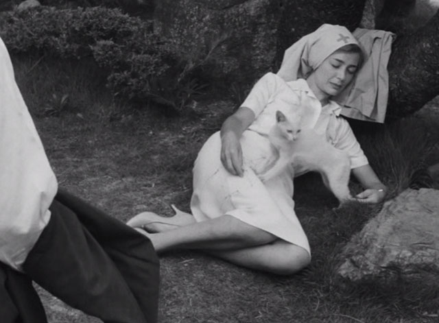 Hiroshima Mon Amour - Elle Emmanuelle Riva resting on ground beside small white cat