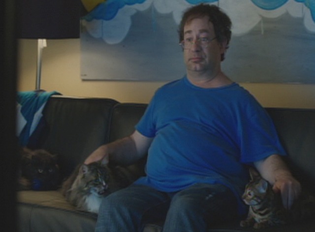 Hit by Lightning - Rciky Blitt sitting with cats on couch