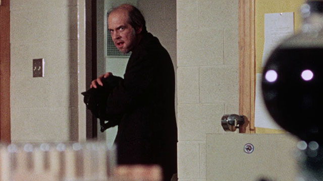 Horror High - janitor Mr. Griggs Jeff Alexander holding black cat in his arms