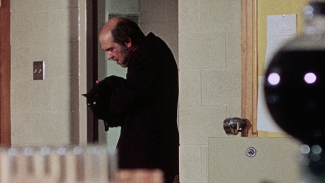 Horror High - janitor Mr. Griggs Jeff Alexander holding black cat in his arms