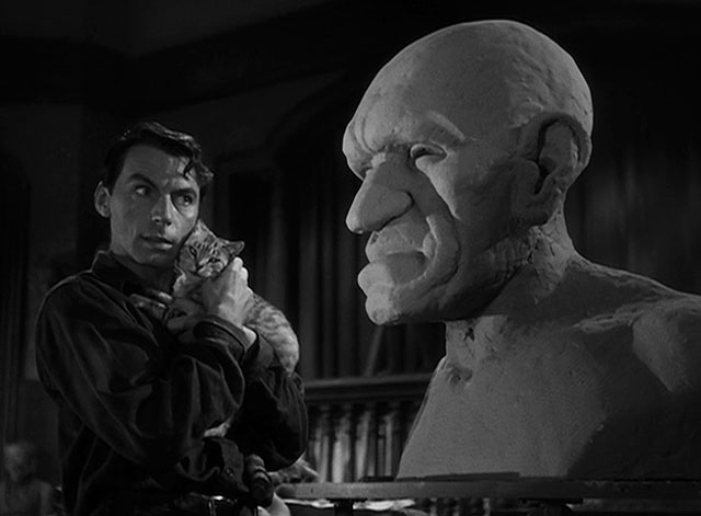 House of Horrors - Marcel Martin Kosleck holding grey tabby cat Pietro as they admire bust of the Creeper