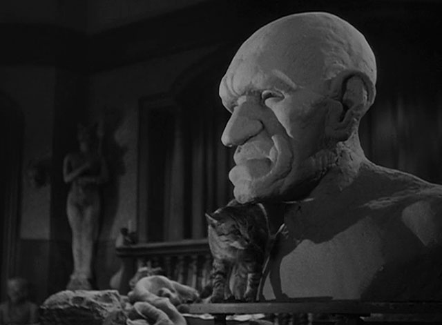 House of Horrors - grey tabby cat Pietro standing on pedestal next to bust of the Creeper
