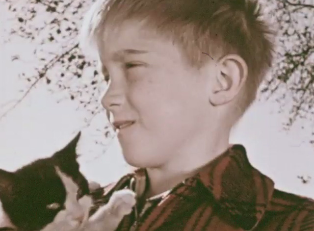How Animals Help Us - boy Jimmy holding tuxedo kitten