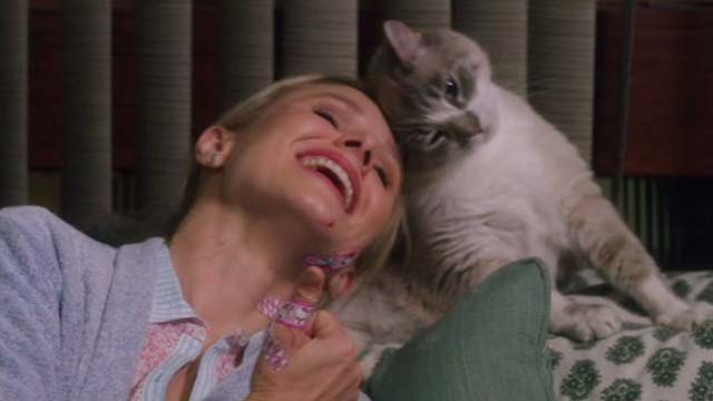 How to Be a Latin Lover - Cindy Kristen Bell rubbing head with cat on couch