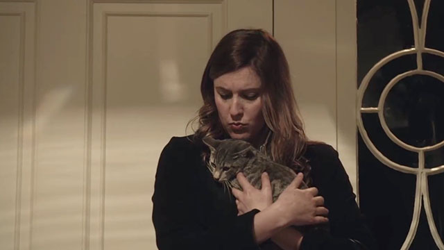 The Humbling - Pegeen Greta Gerwig holding gray tabby cat Emily