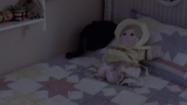 The Hunted - tabby cat Kitty hiding behind pillow on girl's bed