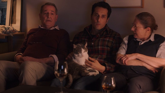 I Am Not an Easy Man - Damien Vincent Elbaz sitting on couch with gray and white cat Rocco and his parents
