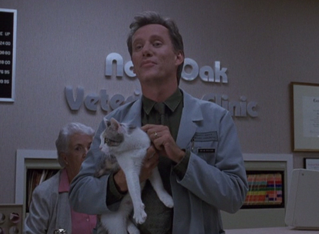 Immediate Family - Michael James Woods holding calico cat in veterinarian's waiting room
