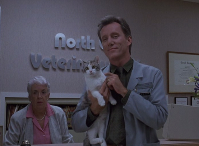Immediate Family - Michael James Woods holding calico cat in veterinarian's waiting room
