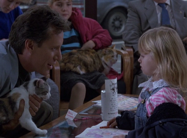 Immediate Family - Michael James Woods holding calico cat and talking to little girl in veterinarian's waiting room