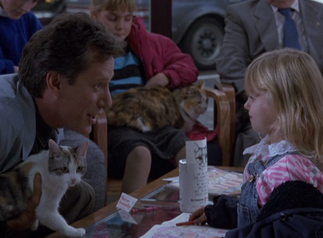 Immediate Family - Michael James Woods holding calico cat and talking to little girl in veterinarian's waiting room