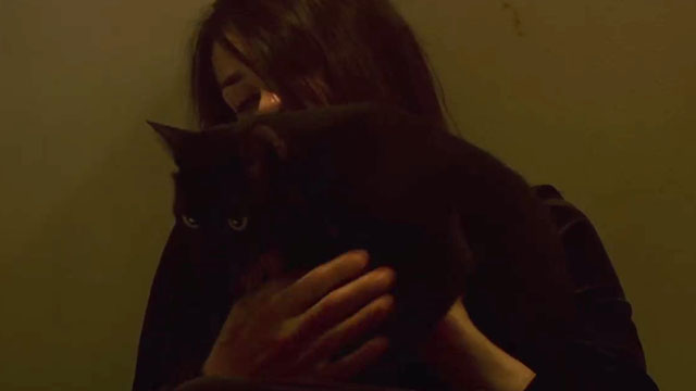 Inside - black cat held by woman Béatrice Dalle