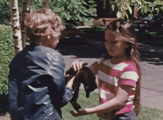 Inside Out - When is Help? - boy Pete handing black kitten to girl Lisa