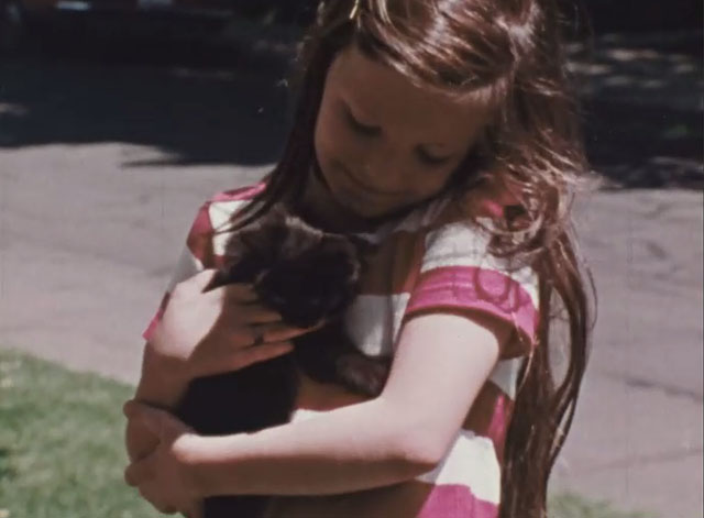 Inside Out - When is Help? - little girl Lisa hugging black kitten
