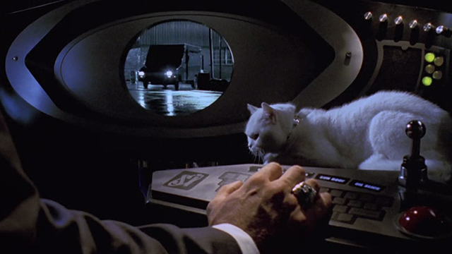 Inspector Gadget - white cat Sniffy sitting on console with Scolex hand
