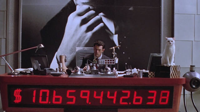 Inspector Gadget - white cat Sniffy sitting on Scolex Rupert Everett desk