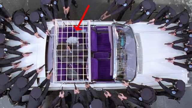 Inspector Gadget - white cat Sniffy and Scolex Rupert Everett surrounded by police in Gadgetmobile