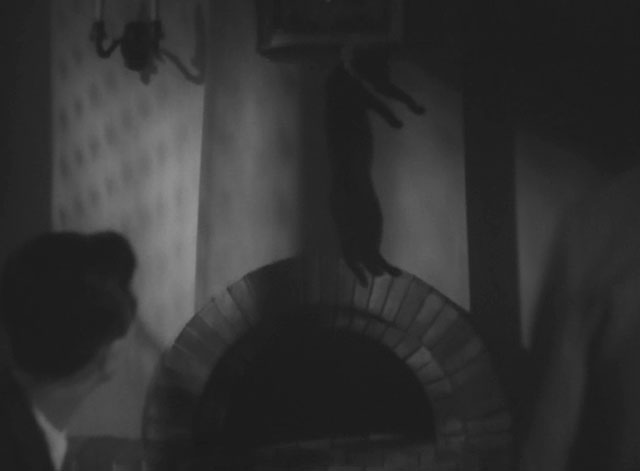 The Invisible Man Appears - Tômei ningen arawaru - black cat with ruffed collar being picked up by scruff by invisible man