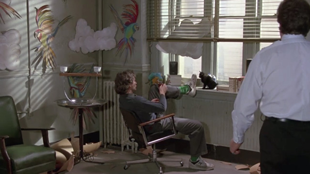 The January Man - Nick Kevin Kline with parrot and black kitten in office
