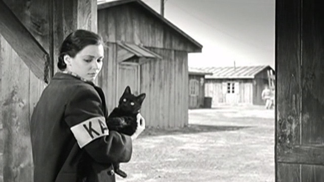 Kapo - Nicole Susan Strasberg holding black cat Faust in doorway