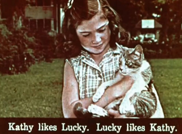 Kathy's Kitten - little girl Kathy holding tabby and white kitten Lucky