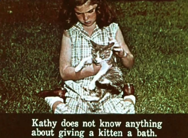 Kathy's Kitten - little girl Kathy holding tabby and white kitten Lucky