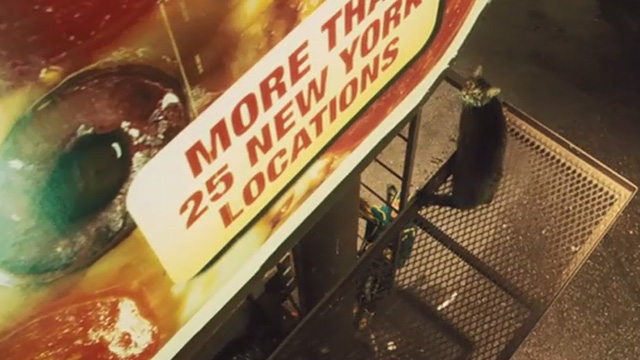 Kick-Ass - tabby cat Mr. Bitey on billboard catwalk with Kick-Ass Aaron Taylor-Johnson climbing up to get him