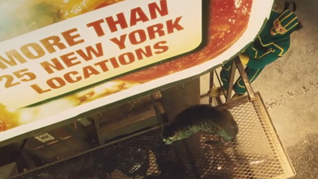 Kick-Ass - tabby cat Mr. Bitey on billboard catwalk with Kick-Ass Aaron Taylor-Johnson climbing up to get him