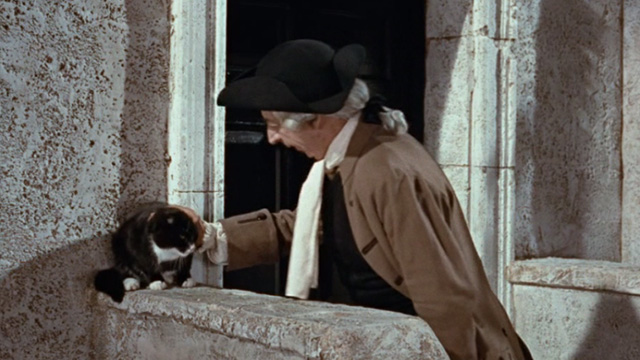 Kidnapped - lawyer Mr. Rankeillor Miles Malleson stopping to pet tuxedo cat sitting outside office