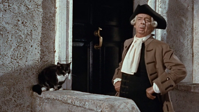 Kidnapped - lawyer Mr. Rankeillor Miles Malleson standing outside office with tuxedo cat to one side
