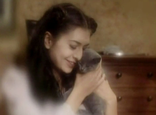 The Killer - woman Sonia Paul hugging blue shorthair kitten