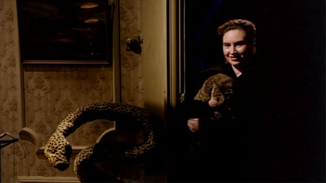 Killing Dad - Luisa Laura Del Sol holding brown tabby cat Sebastian Sebby in doorway