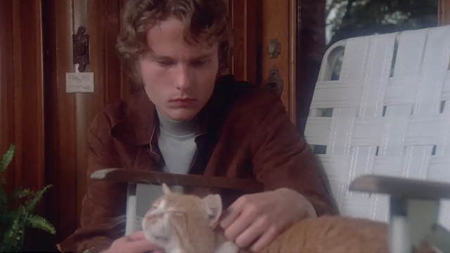 The Killing Kind - Terry Jon Savage petting ginger and white tabby cat