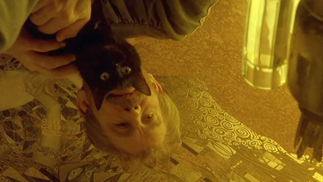 Klimt - John Malkovich holding black cat over gold leaf artwork