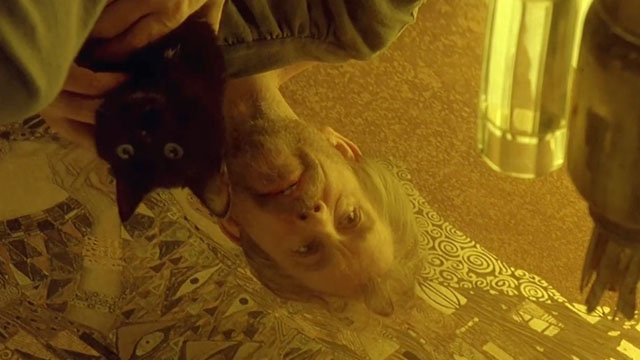 Klimt - John Malkovich holding black cat over gold leaf artwork