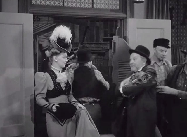 Klondike Kate - Ann Savage with Judge Crossit George Cleveland holding small tabby cat Mr. Blackstone entering saloon