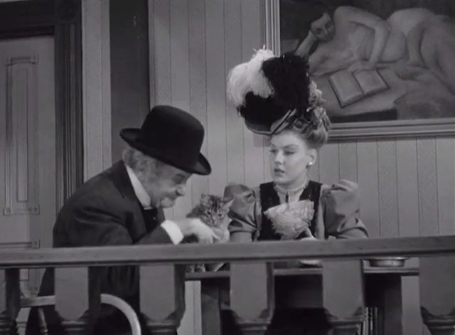 Klondike Kate - Ann Savage and Judge Crossit George Cleveland at table with small tabby cat Mr. Blackstone