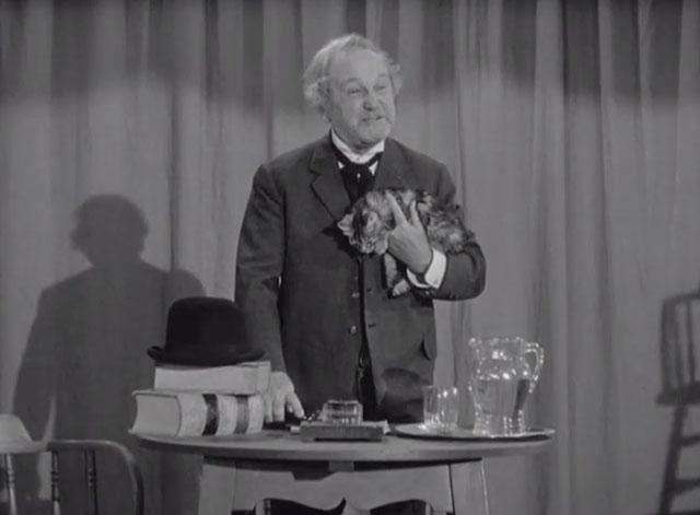Klondike Kate - Judge Crossit George Cleveland holding small tabby cat Mr. Blackstone on stage