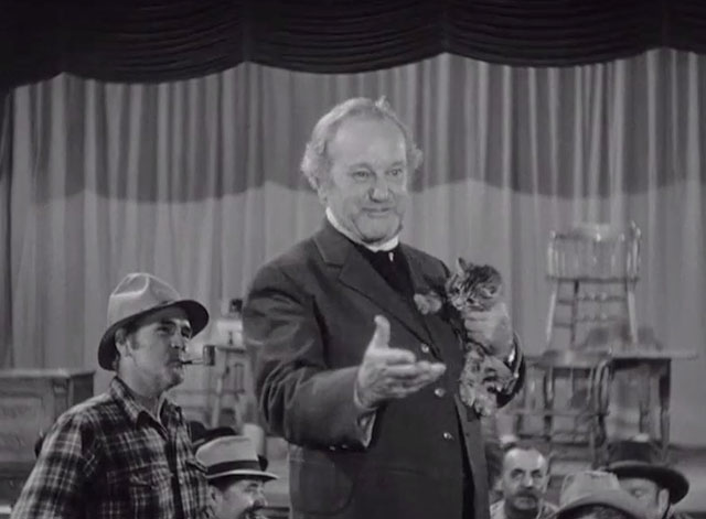 Klondike Kate - Judge Crossit George Cleveland holding small tabby cat Mr. Blackstone in saloon
