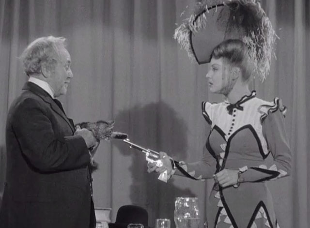 Klondike Kate - Ann Savage pointing gun at Judge Crossit George Cleveland holding small tabby cat Mr. Blackstone on stage