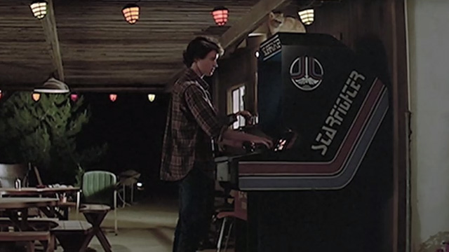 The Last Starfighter - orange tabby cat on top of Starfighter arcade game played by Alex Lance Guest at night