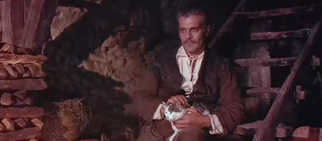 The Last Valley - Vogel Omar Sharif petting brown and white tabby cat on lap
