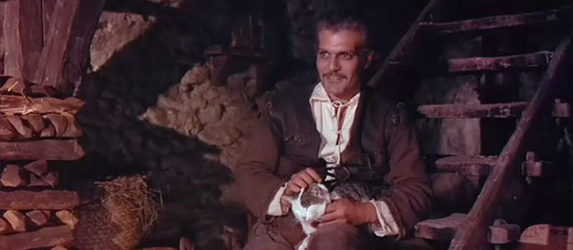 The Last Valley - Vogel Omar Sharif petting brown and white tabby cat on lap
