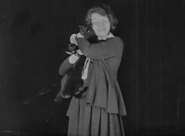 The Late Miss Billie Carleton - longhair black cat being held by Billie Carleton