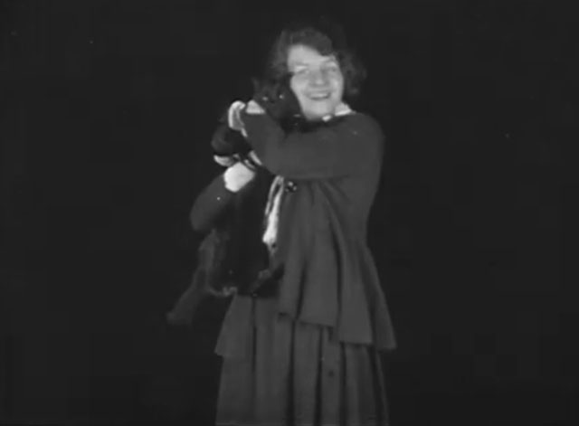 The Late Miss Billie Carleton - longhair black cat being held by Billie Carleton