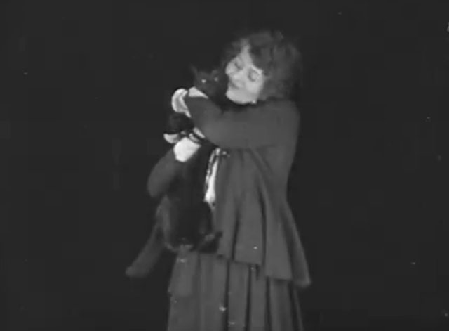 The Late Miss Billie Carleton - longhair black cat being held by Billie Carleton